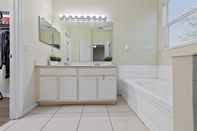 bathroom with vanity, tile patterned flooring, and a bathtub