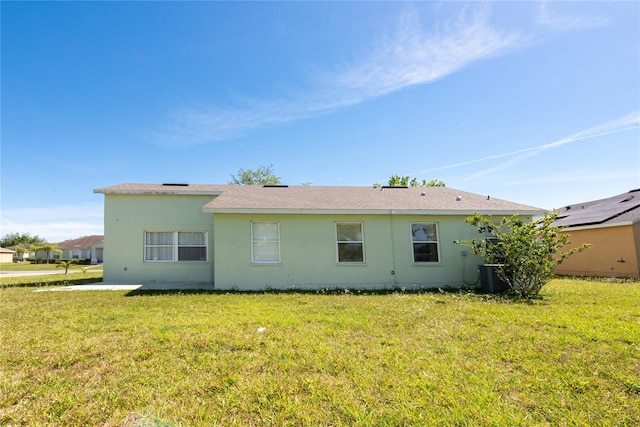 back of property featuring a yard