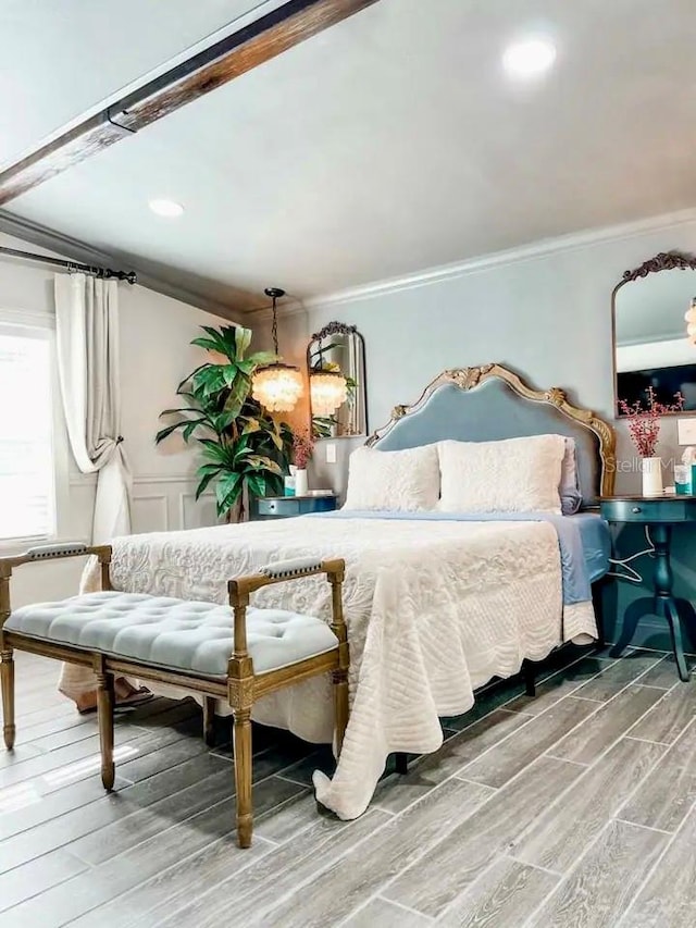 bedroom with hardwood / wood-style floors and ornamental molding