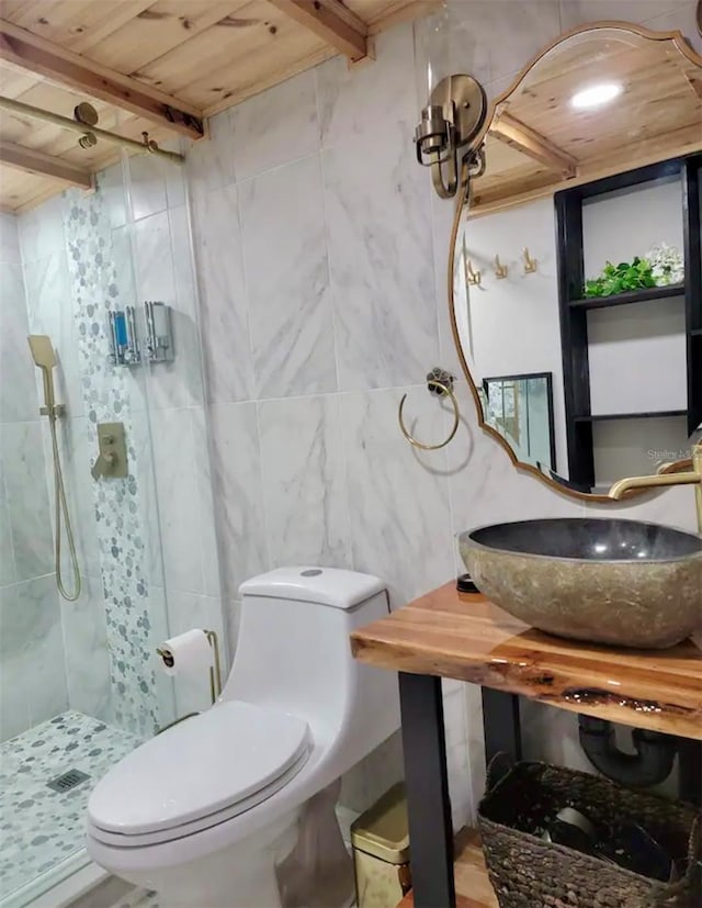 bathroom featuring tiled shower, tile walls, wooden ceiling, sink, and toilet