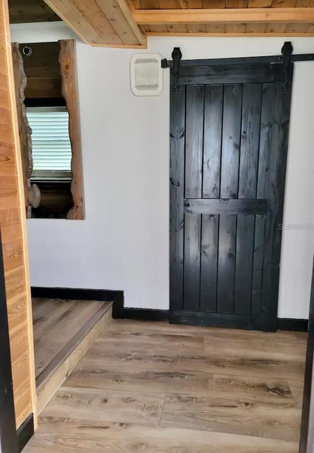 interior space with light hardwood / wood-style floors and a barn door