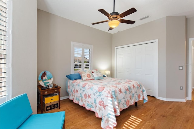 bedroom with ceiling fan, a closet, and light wood-type flooring