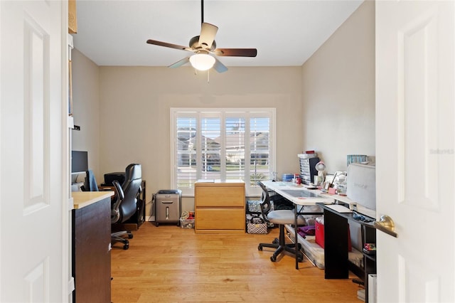 home office with ceiling fan and light hardwood / wood-style flooring