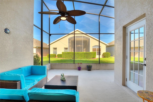 sunroom / solarium featuring ceiling fan