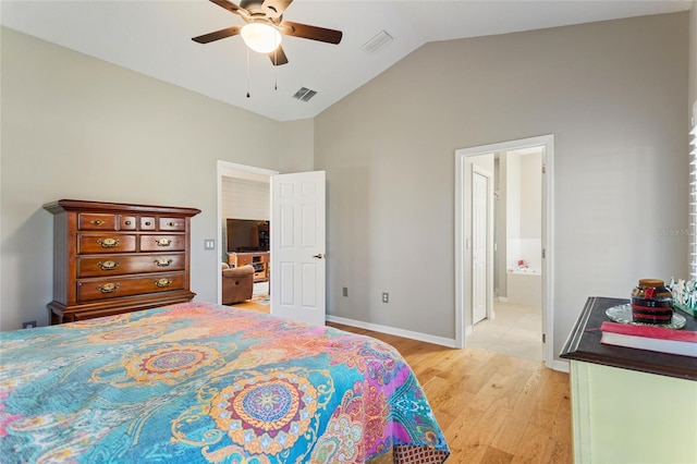 bedroom featuring ceiling fan, lofted ceiling, ensuite bath, and light hardwood / wood-style floors