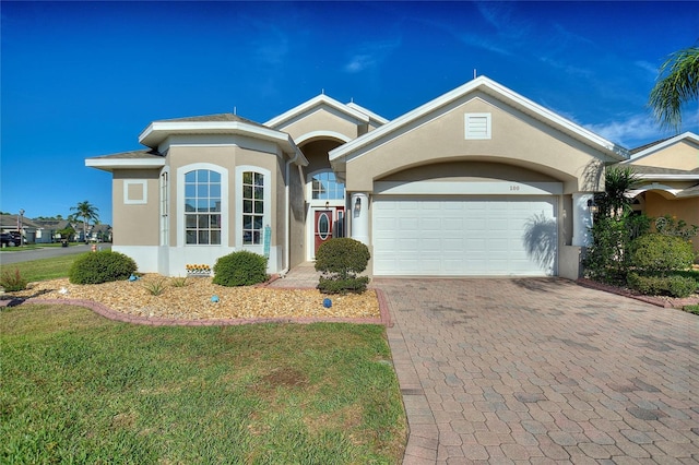 ranch-style home with a front yard and a garage