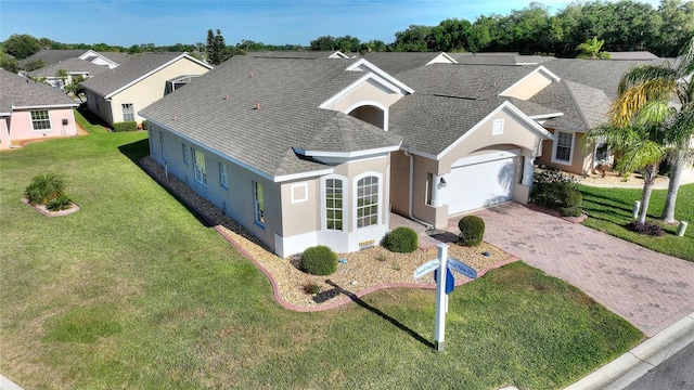 view of front of house with a front lawn and a garage