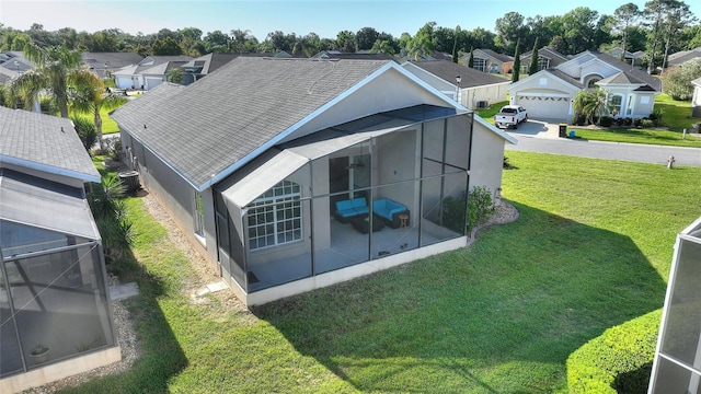 rear view of house featuring a yard and a garage