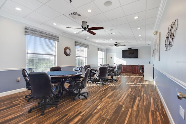 dining area featuring ceiling fan, ornamental molding, a paneled ceiling, and dark wood-type flooring