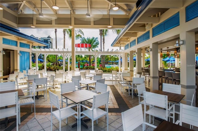 view of patio / terrace with ceiling fan and a bar