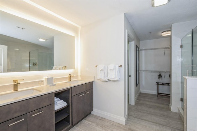 bathroom featuring dual vanity and hardwood / wood-style flooring