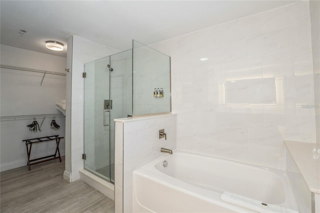 bathroom with separate shower and tub