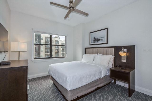 bedroom featuring dark carpet and ceiling fan