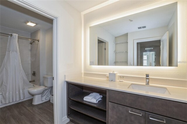 full bathroom featuring hardwood / wood-style flooring, toilet, shower / bathtub combination with curtain, and vanity