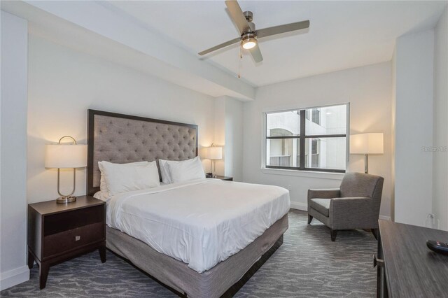 bedroom featuring dark carpet and ceiling fan