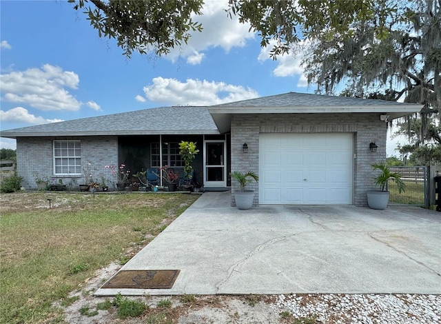 ranch-style house with a garage and a front yard