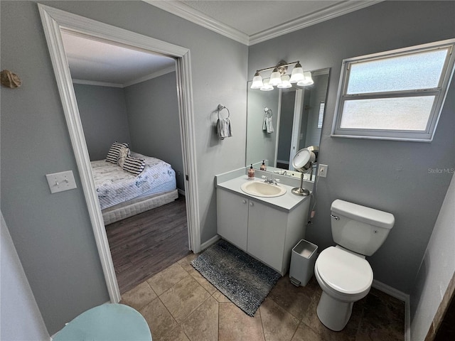 bathroom featuring vanity with extensive cabinet space, toilet, tile floors, and crown molding