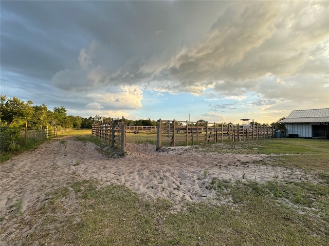 view of yard with a rural view and an outdoor structure