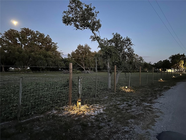 yard at dusk with a rural view