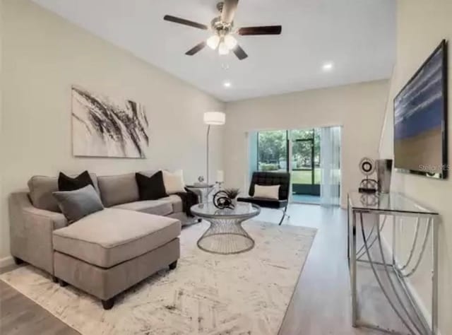 living room featuring a ceiling fan and recessed lighting