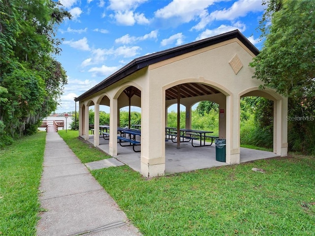 view of home's community featuring a lawn and a patio