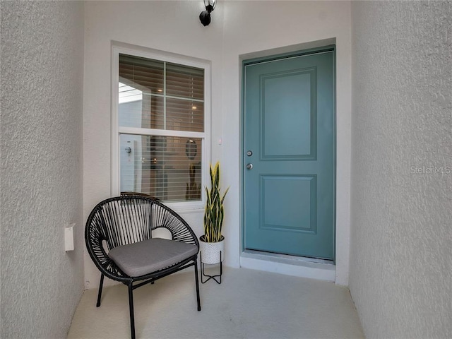 entrance to property with stucco siding