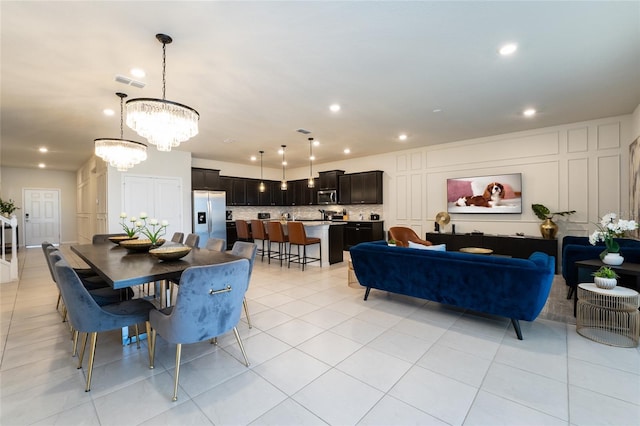 tiled dining area featuring an inviting chandelier