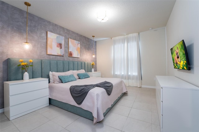 bedroom with a textured ceiling and light tile floors