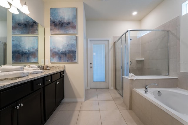 bathroom with tile flooring, independent shower and bath, and vanity