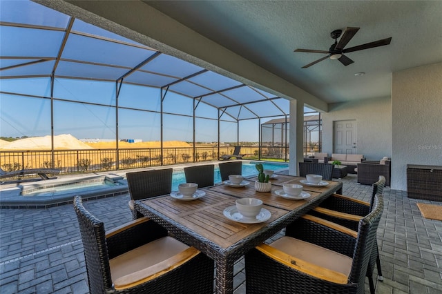 sunroom with ceiling fan and a mountain view