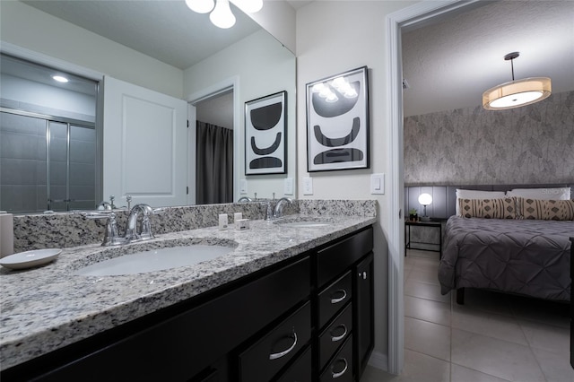 bathroom with double sink, tile floors, and oversized vanity