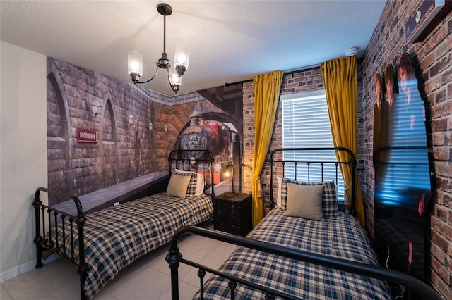 bedroom featuring an inviting chandelier, brick wall, and light tile floors