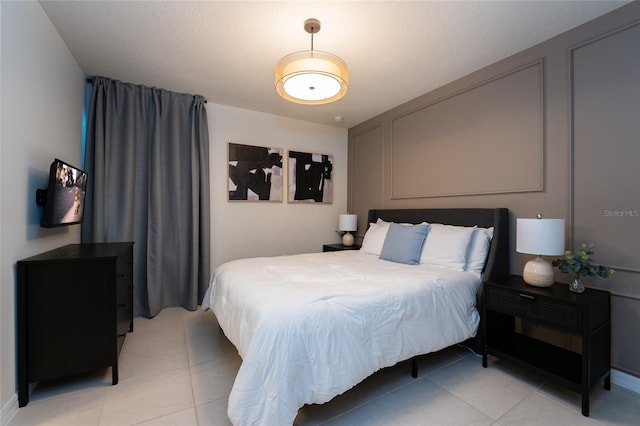 bedroom with light tile floors