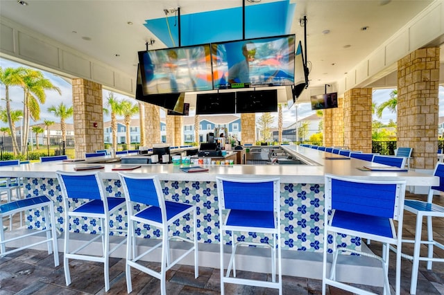 exterior space featuring a kitchen breakfast bar and hanging light fixtures