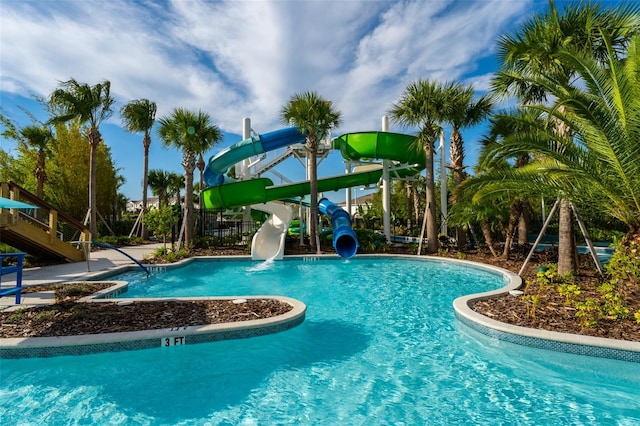 view of swimming pool with a water slide