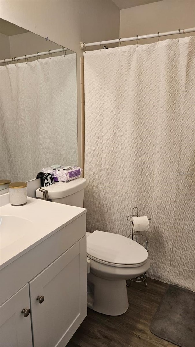 bathroom with vanity, hardwood / wood-style flooring, and toilet