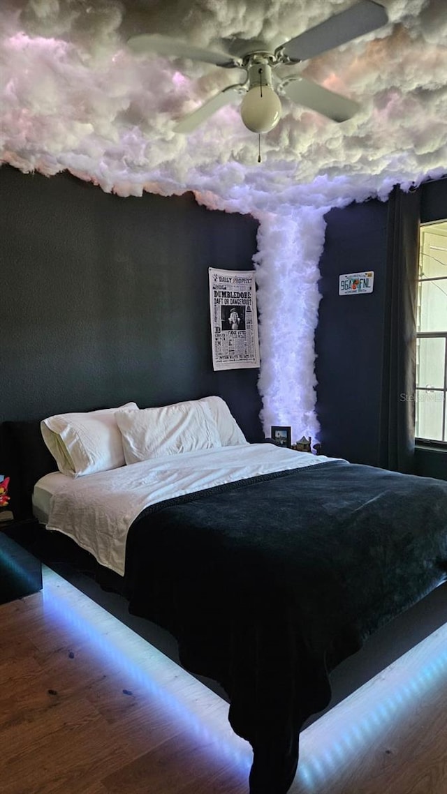 bedroom featuring wood-type flooring and ceiling fan