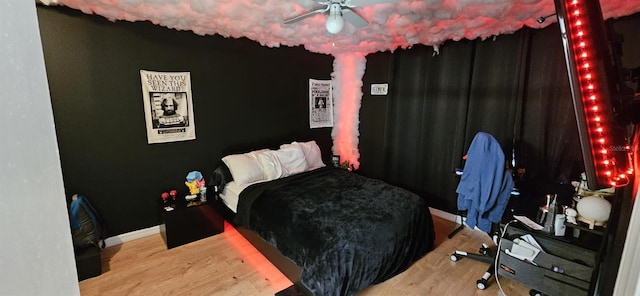 bedroom with ceiling fan and hardwood / wood-style flooring