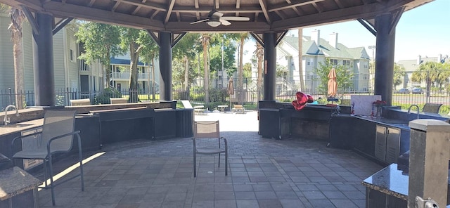 view of patio / terrace featuring an outdoor wet bar, ceiling fan, and a gazebo