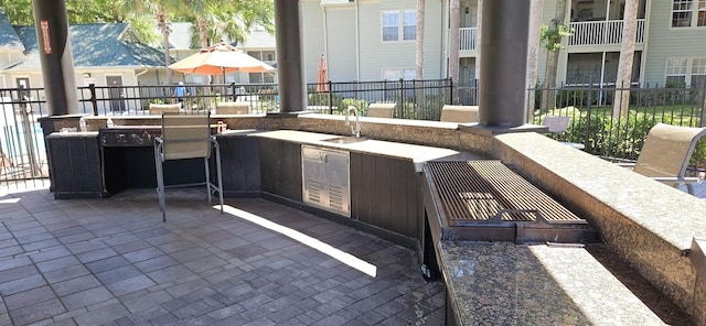 view of patio featuring sink and a balcony