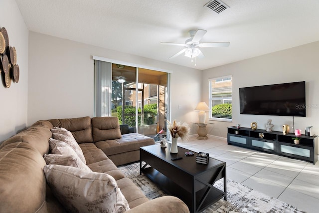 living room featuring ceiling fan and light tile floors