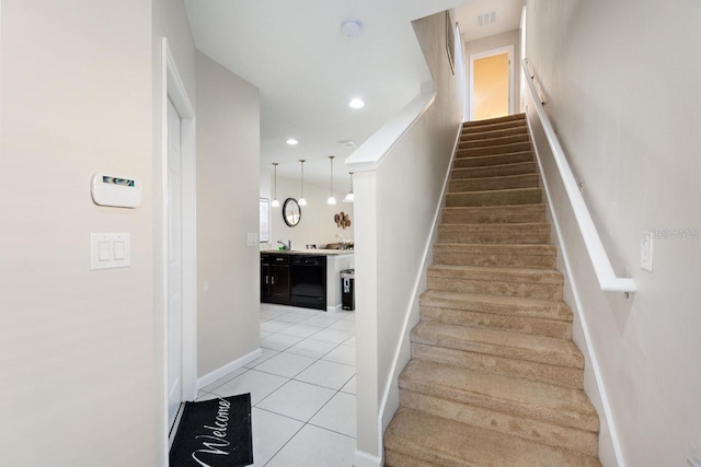 stairway featuring light tile floors