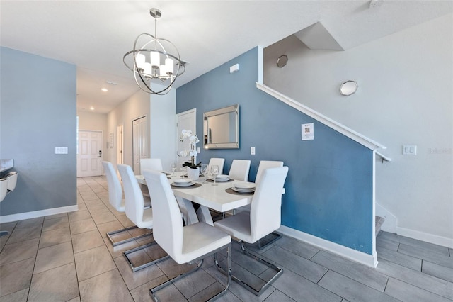 tiled dining room featuring an inviting chandelier