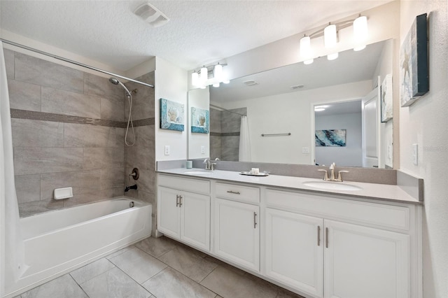 bathroom featuring dual bowl vanity, a textured ceiling, shower / bath combo, and tile floors