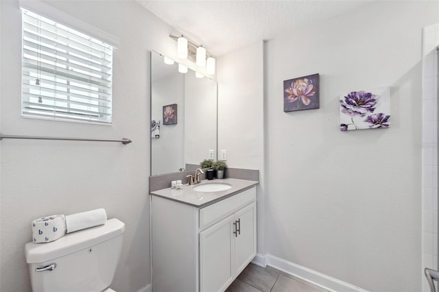 bathroom featuring toilet, tile floors, and large vanity