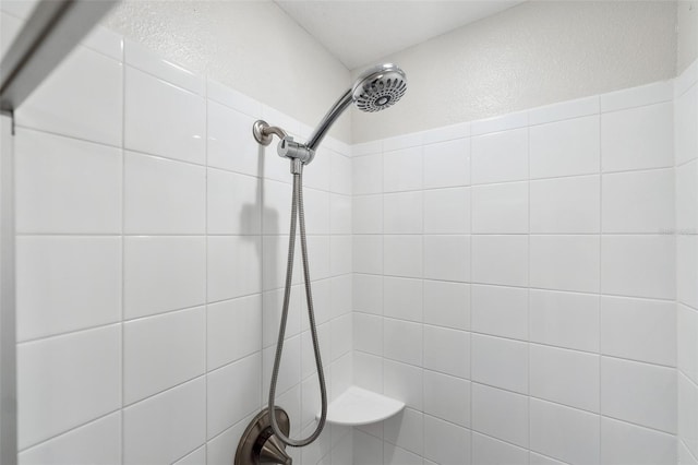 bathroom with tiled shower