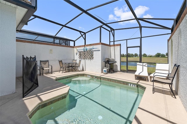 view of swimming pool featuring glass enclosure and a patio area