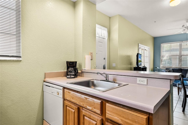 kitchen with light tile flooring, sink, ceiling fan, and dishwasher