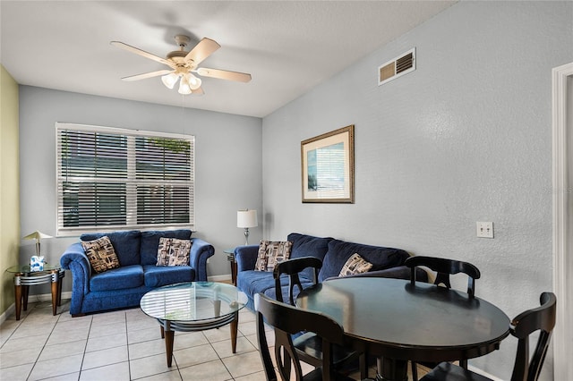 dining space featuring ceiling fan and light tile floors