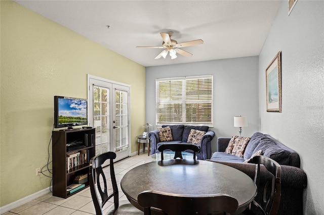 dining room featuring french doors, ceiling fan, and light tile flooring